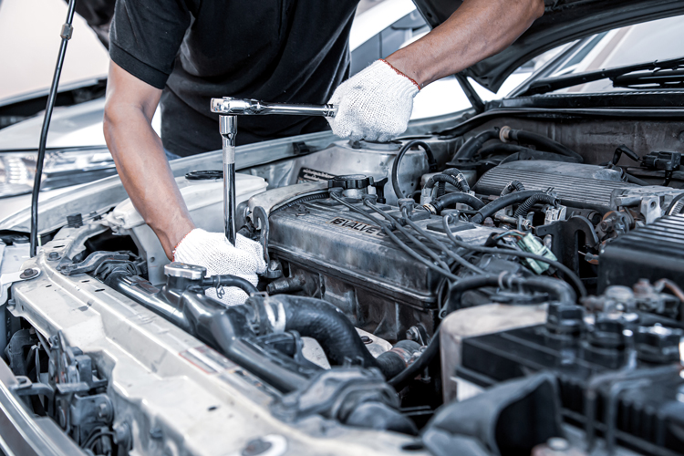 Aut technician working on a car engine