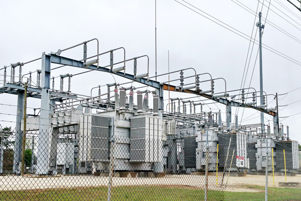 view of power station behind a fence in the daylight